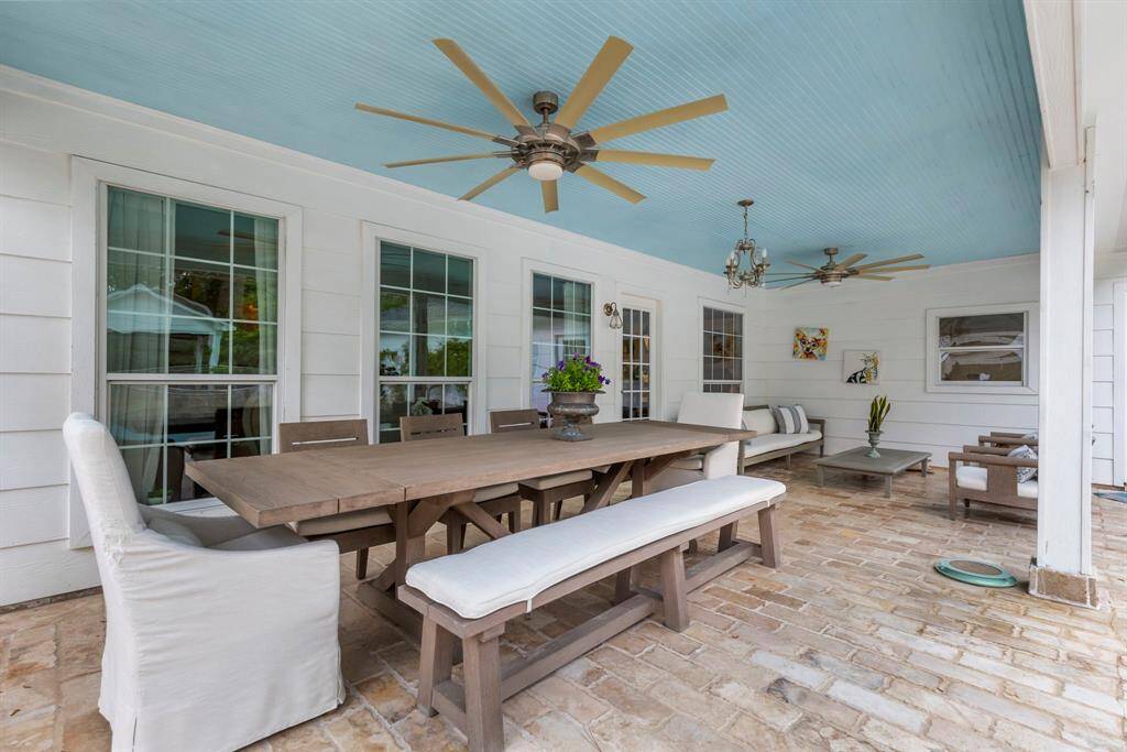 The expansive covered patio provides plenty of room for outdoor dining and entertaining, making it the perfect space to host family and friends.