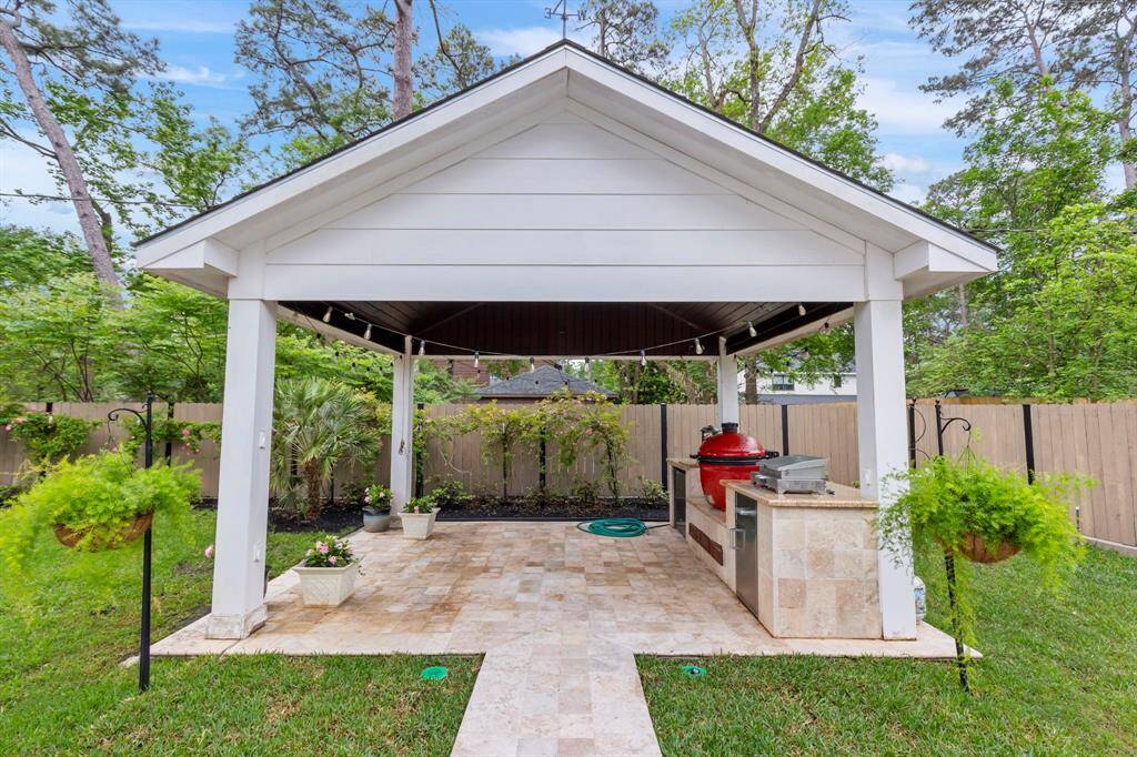 At the back of the property, you'll find a fully equipped covered outdoor kitchen, perfect for al fresco dining and entertaining in style.