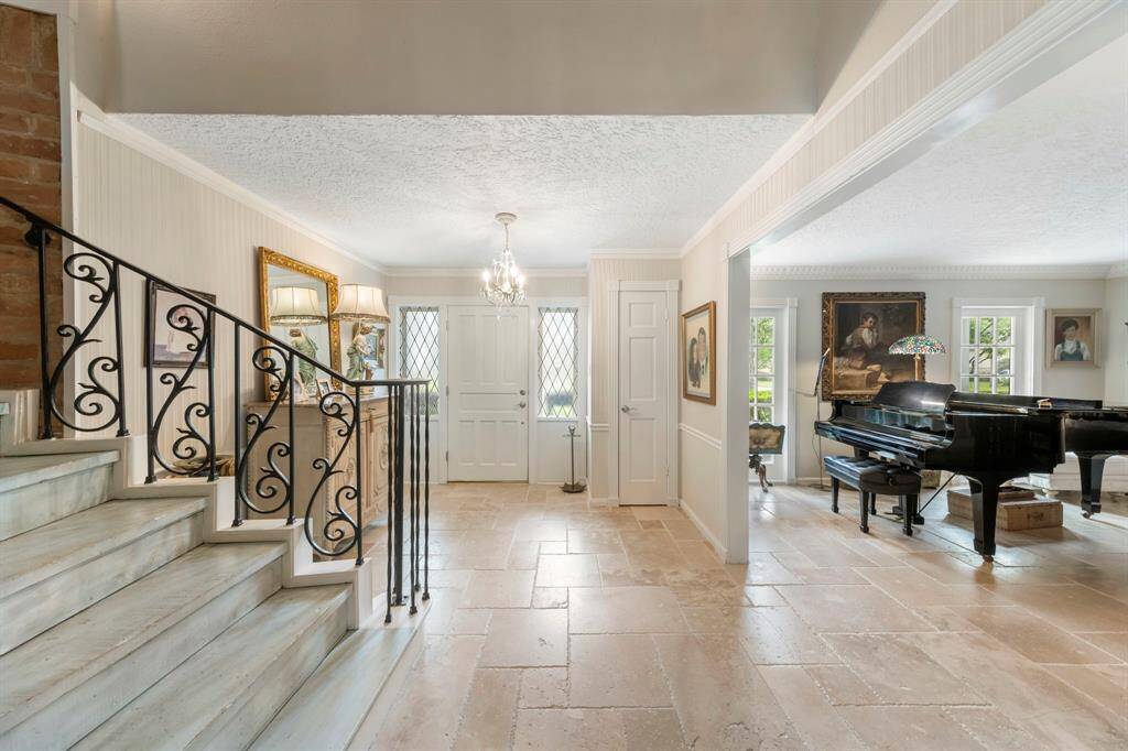 Welcoming formal entryway with a convenient coat closet leads to elegant formal living and dining spaces at the front of the home.