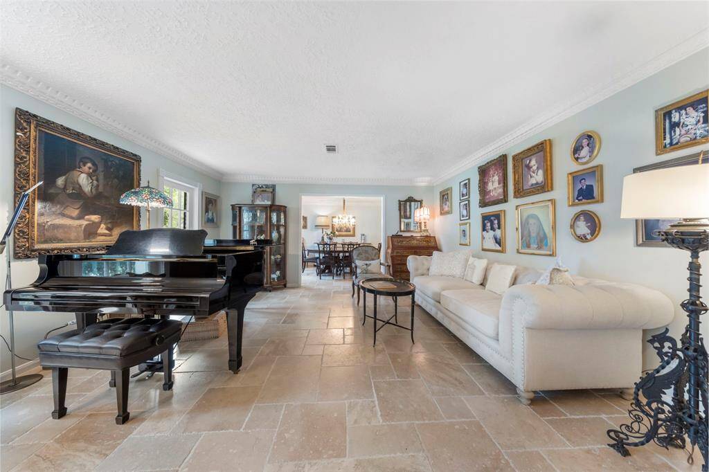 Expansive formal living room with picturesque views of the beautifully landscaped front yard.