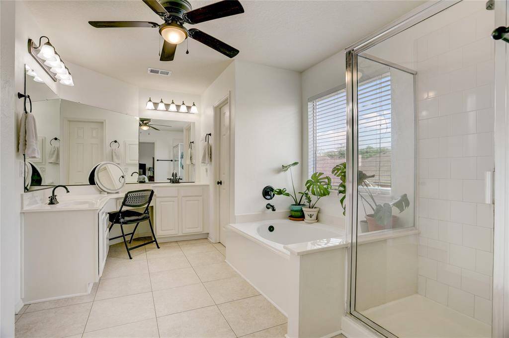 Primary bathroom is filled with natural light and has a huge walk-in closet!