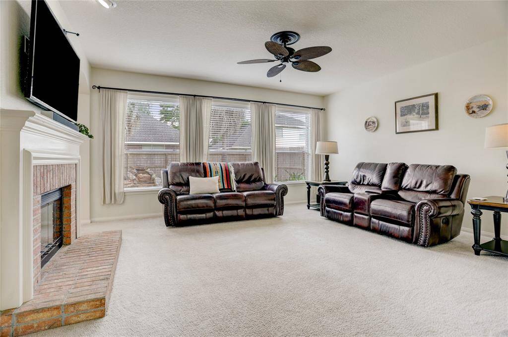 Spaciousliving room is light and bright and features a two sided fire place.