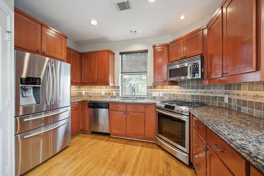 Stainless-steel appliances and continuous wood floors