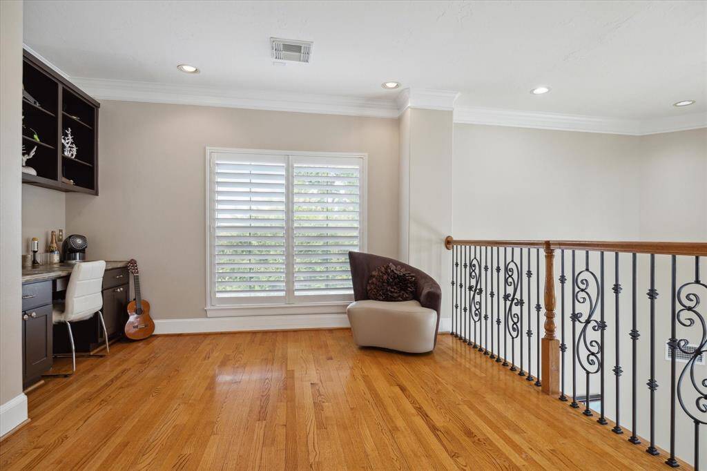 Third floor Flex Space features built-ins and a desk while being open to the second floor living spaces