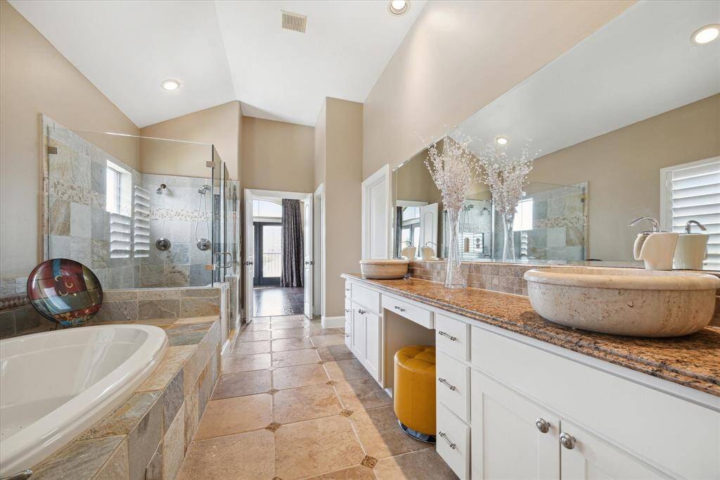 Primary Bathroom, connected to the Primary Bedroom, with double sinks and tile floors