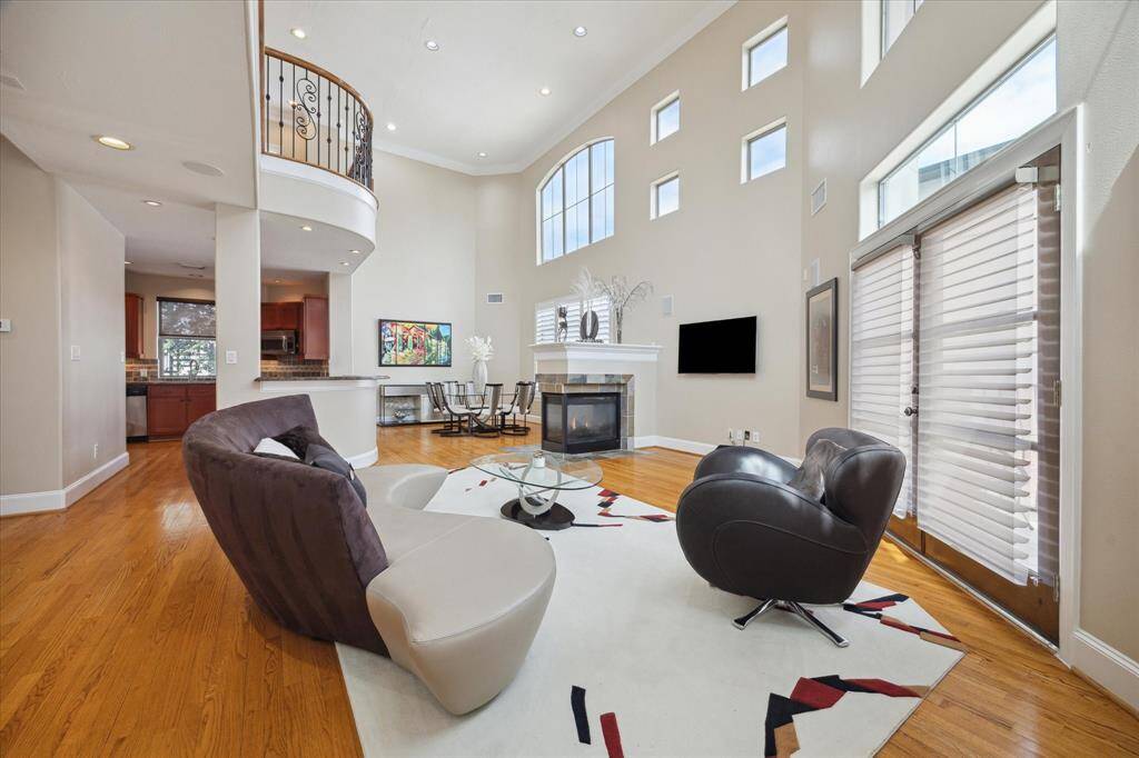 Family Room features a wall of windows, a gas log fireplace and wood floors