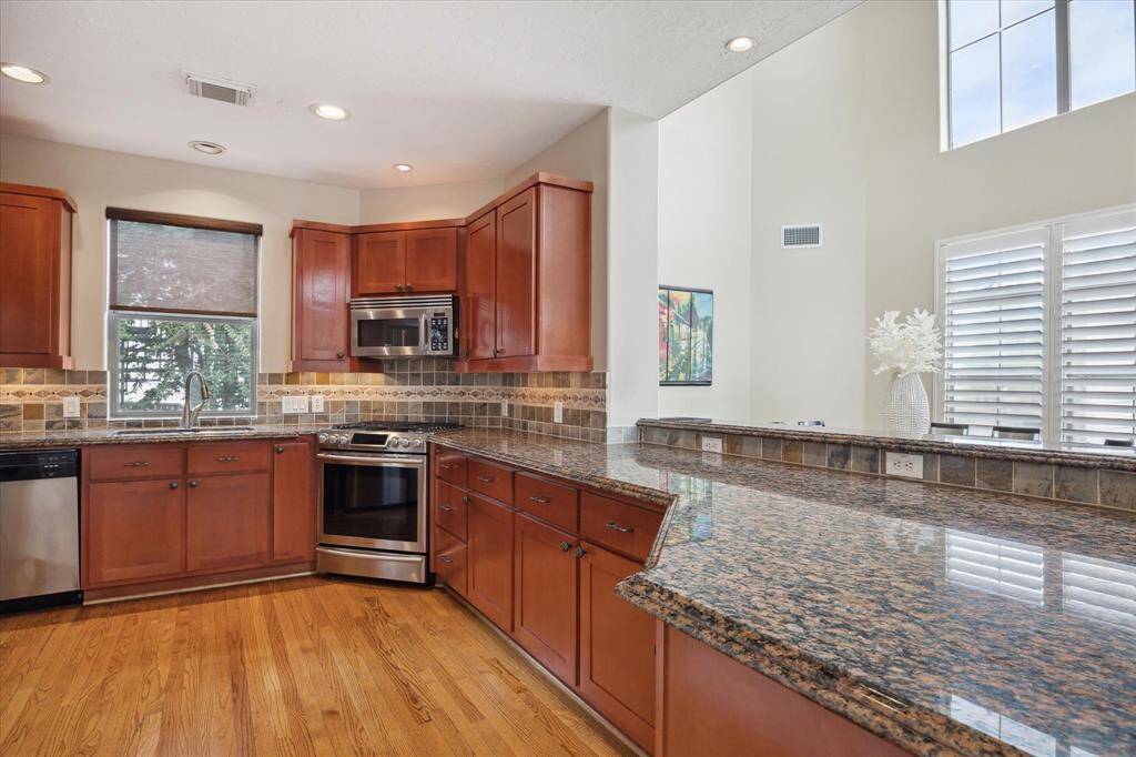 Open Kitchen with wood cabinets and granite countertops
