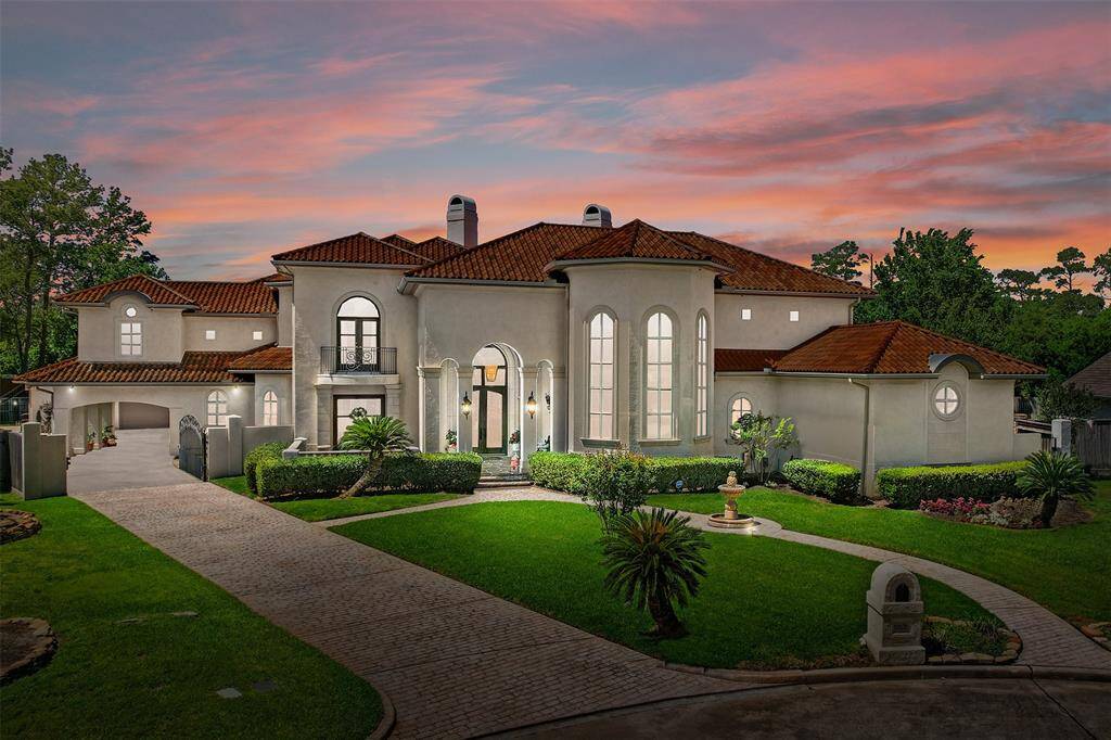 Welcome to 6606 Centre Place Circle! This stunning Mediterranean-style home features elegant arches, large windows, and a well-manicured front yard with a fountain. The exterior showcases a clay tile roof and a spacious driveway, creating a luxurious and inviting atmosphere.