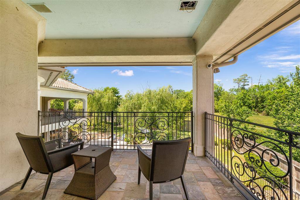 The home features several outdoor balconies, each providing a peaceful retreat with picturesque views of the verdant landscape.