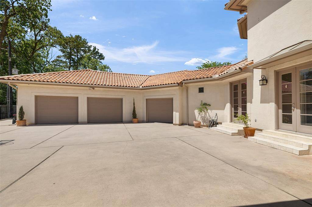 This spacious three-car garage offers ample storage and parking space, complemented by an expansive, privately fenced driveway that provides plenty of room for additional vehicles or recreational toys.