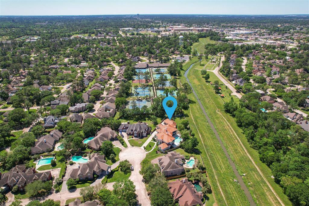 This aerial photo offers a glimpse of the incredible amenities at Wimbledon Champions Estates, a private gated community. Residents enjoy access to tennis courts, expansive green spaces for sports and events, a swimming pool, picnic area, volleyball court, and a fun, interactive park and playground for all ages.