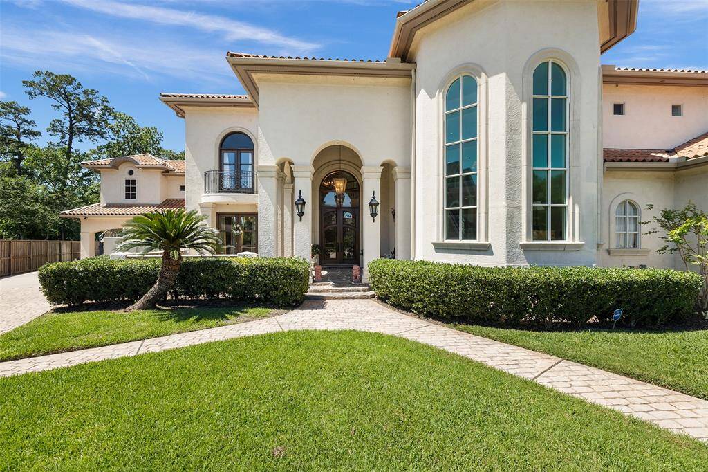 Elegance is the theme of this home: From the tall, arched windows to the meticulously manicured lawn, this Mediterranean-inspired home exudes luxury and elegance at every turn.