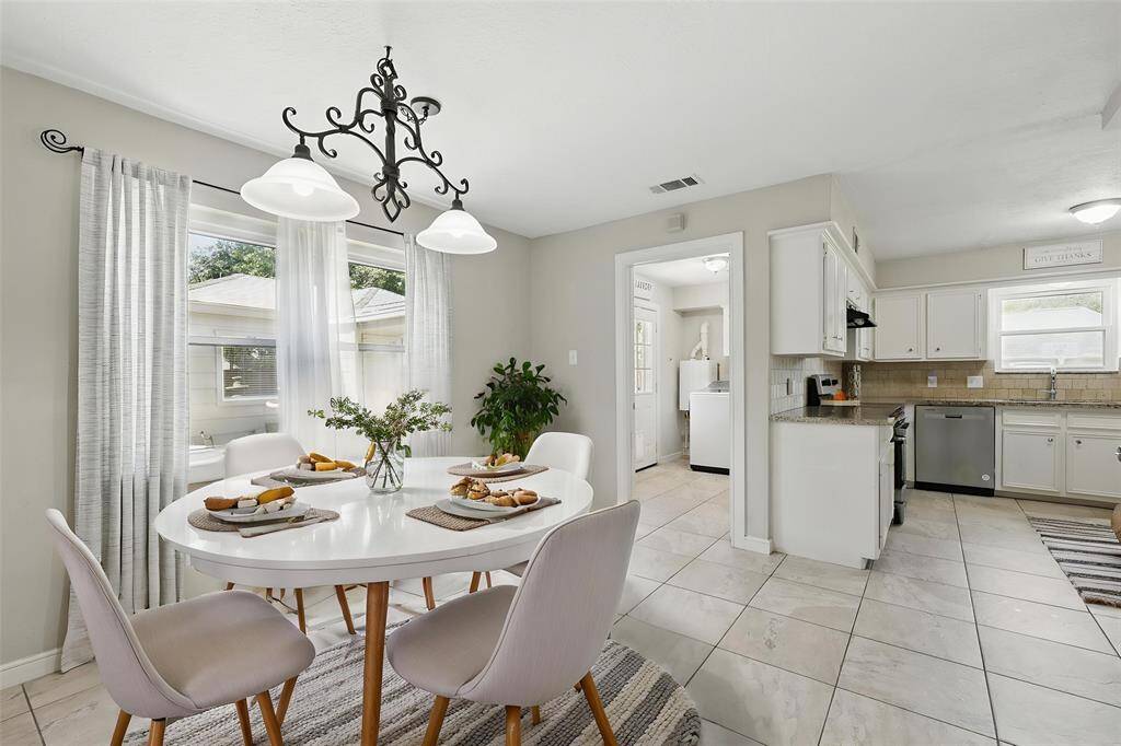 This breakfast area has been virtually staged to help illustrate its potential as a cozy and inviting dining space.