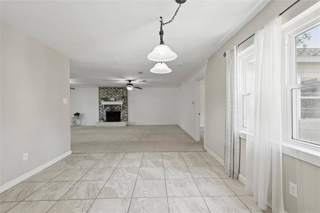 Check out this spacious breakfast area, complete with tile flooring and a warm, inviting atmosphere that sets the tone for the rest of the home.Its open-concept design flows effortlessly into the formal family room, allowing you to stay connected with loved ones while enjoying meals or relaxing.