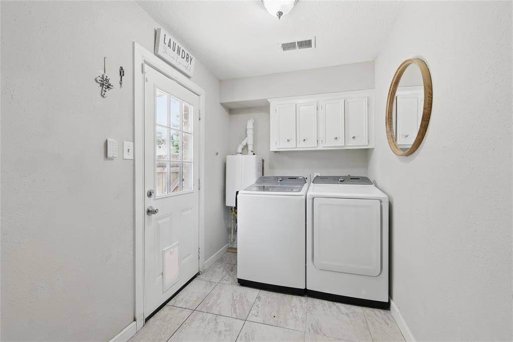 Conveniently located just off the kitchen, the laundry room offers easy access to the back patio area.This functional space also features one of the home’s two tankless water heaters, adding efficiency and modern convenience.