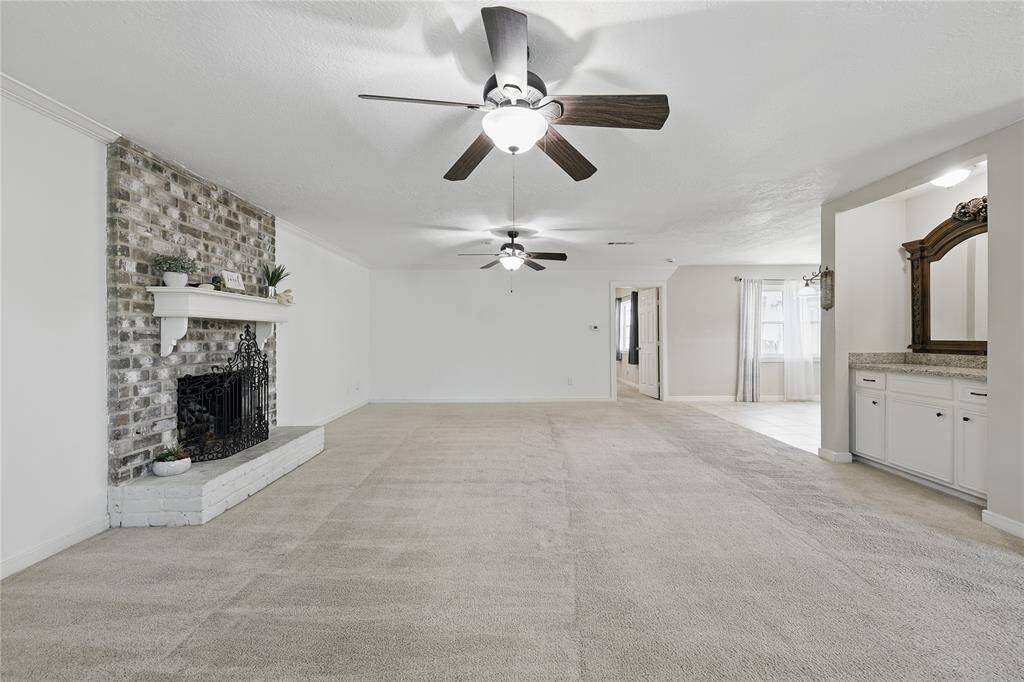 Enjoy entertaining in this spacious family room, complete with crown molding, a cozy fireplace, and a stylish bar area.Whether you're hosting friends or relaxing with family, this room offers both comfort and elegance.