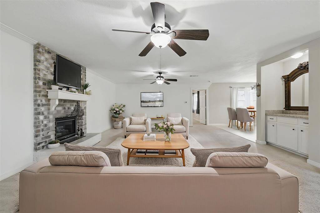 This photo has been virtually staged to highlight the endless possibilities of this oversized family room.With plenty of space to get creative, whether you're hosting a movie night, game day, or just kicking back with loved ones, this room is ready for all your fun moments!