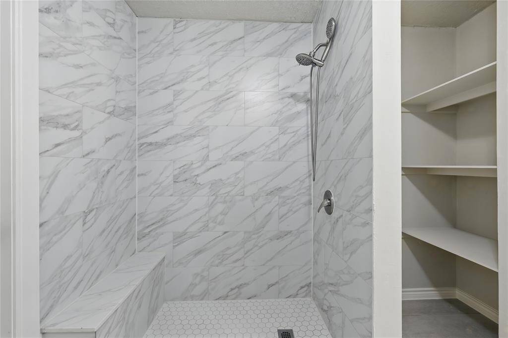 The downstairs bedroom features a spacious walk-in closet, offering plenty of storage and convenience.