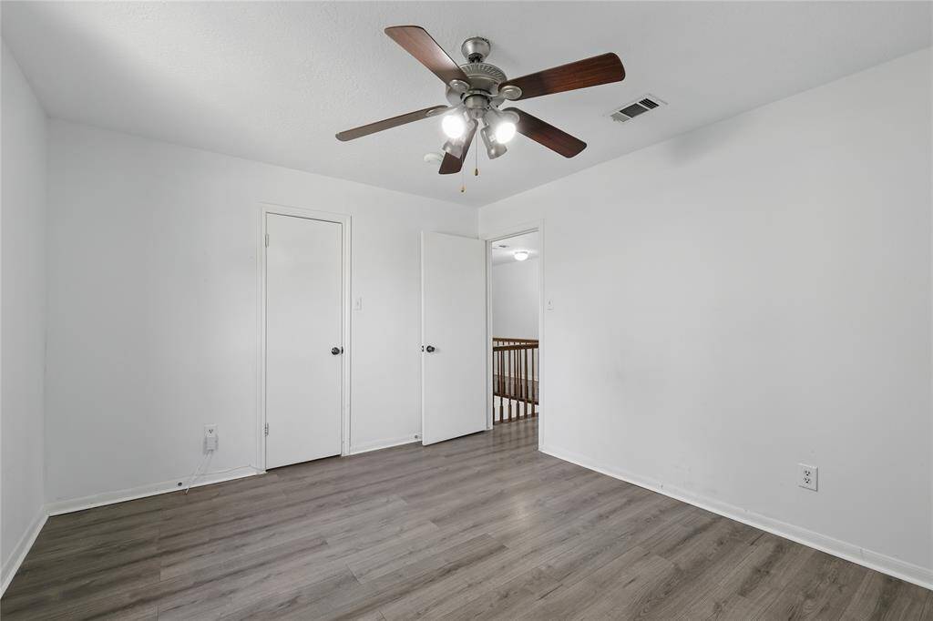 Welcome to this bright and inviting secondary bedroom, featuring sleek LVP flooring and ample closet space—perfect for all your storage needs.