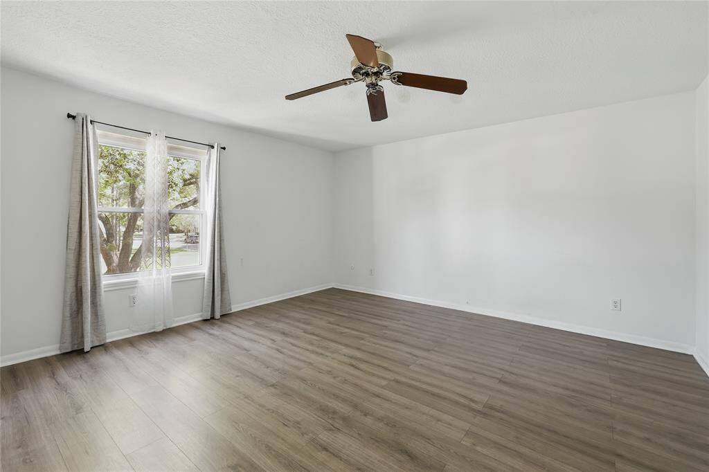 This primary bedroom, located just off the stairs, is sure to impress with its spacious layout and inviting atmosphere.It’s the perfect place to unwind and relax after a long day, offering both comfort and style.