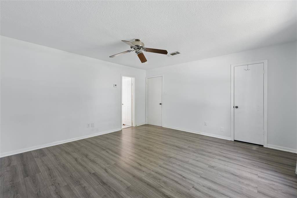 This primary bedroom, located just off the stairs, is sure to impress with its spacious layout and inviting atmosphere.It’s the perfect place to unwind and relax after a long day, offering both comfort and style.
