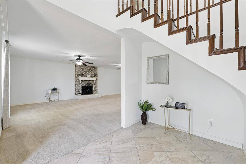 Step into a foyer that immediately sets the tone for the home’s vibrant and welcoming atmosphere.Soaring ceilings, abundant natural light, and an effortless transition into the main living areas make this entryway both elegant and inviting. Whether you're welcoming guests or returning after a long day, the space radiates warmth and style—offering a glimpse into the thoughtful design and comfort found throughout the rest of the home.