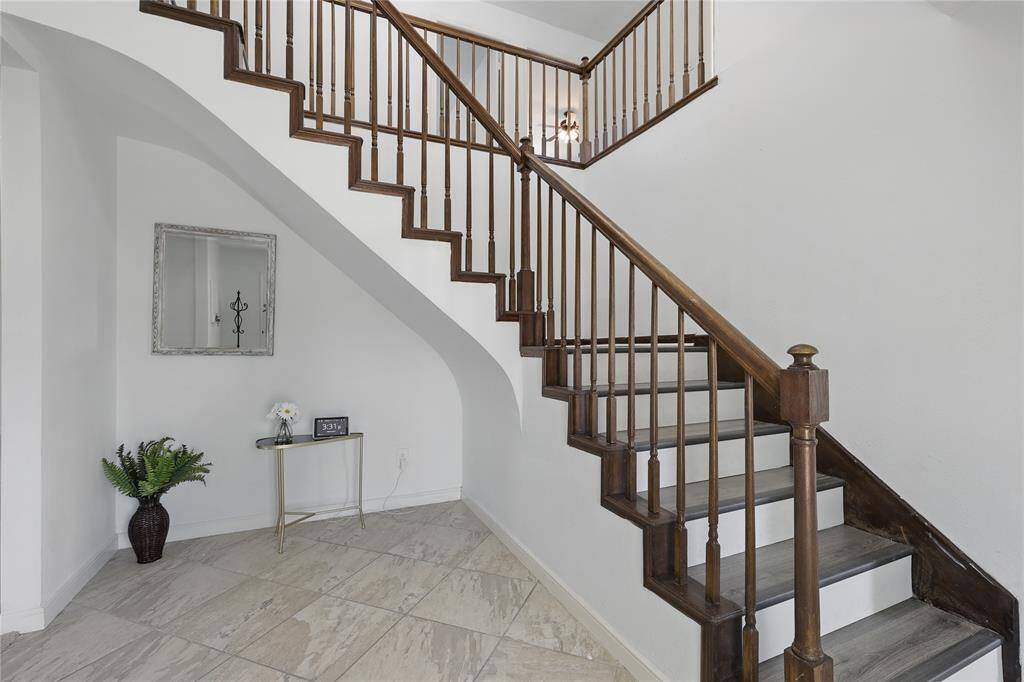 Step into a foyer that immediately sets the tone for the home’s vibrant and welcoming atmosphere.Soaring ceilings, abundant natural light, and an effortless transition into the main living areas make this entryway both elegant and inviting. Whether you're welcoming guests or returning after a long day, the space radiates warmth and style—offering a glimpse into the thoughtful design and comfort found throughout the rest of the home.