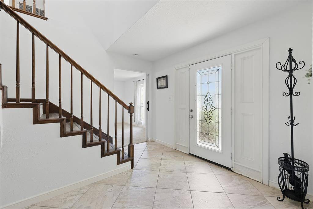 Step into a foyer that immediately sets the tone for the home’s vibrant and welcoming atmosphere.