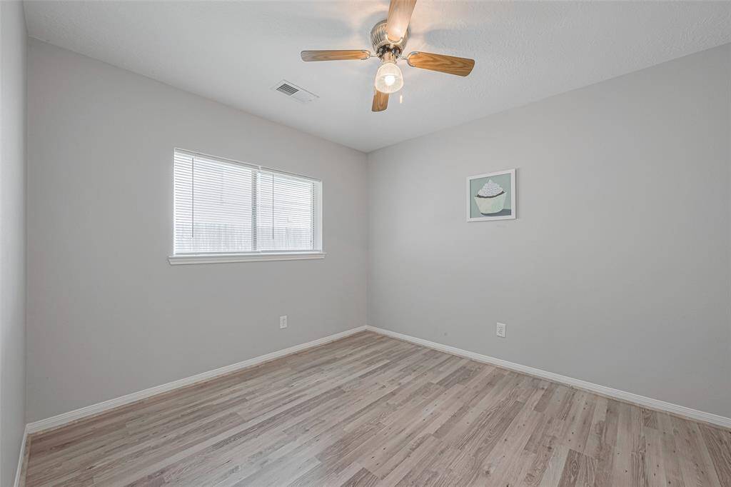 Imagine making this lovely bedroom your own. With its clean lines, ample natural light, and ceiling fan, it offers a versatile space to create your ideal sanctuary.