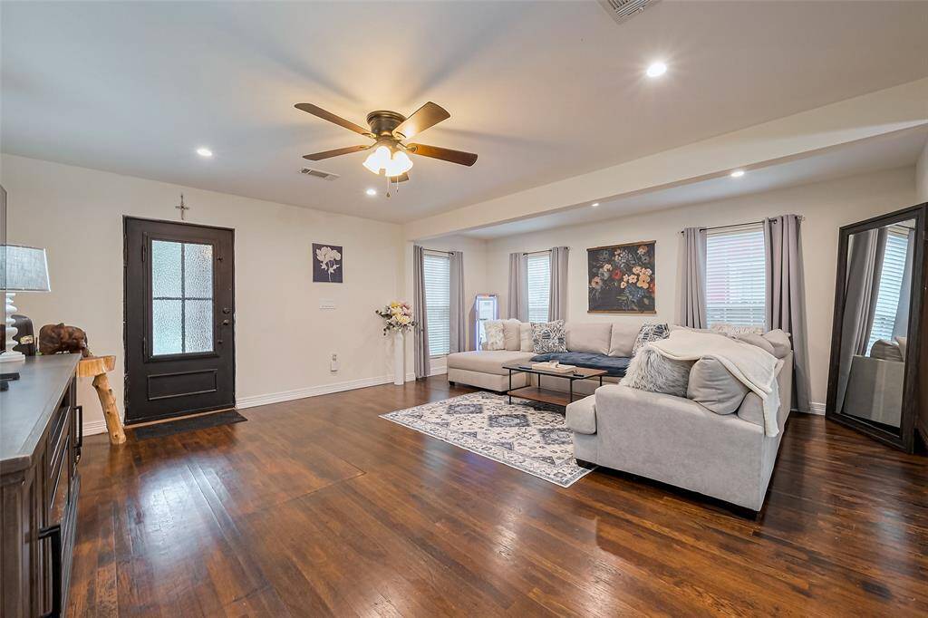 The full bathroom is well-appointed with a dual-sink vanity and a large mirror. Beneath the vanity, there's plenty of storage, and the separate enclosed shower area adds a touch of privacy and convenience.