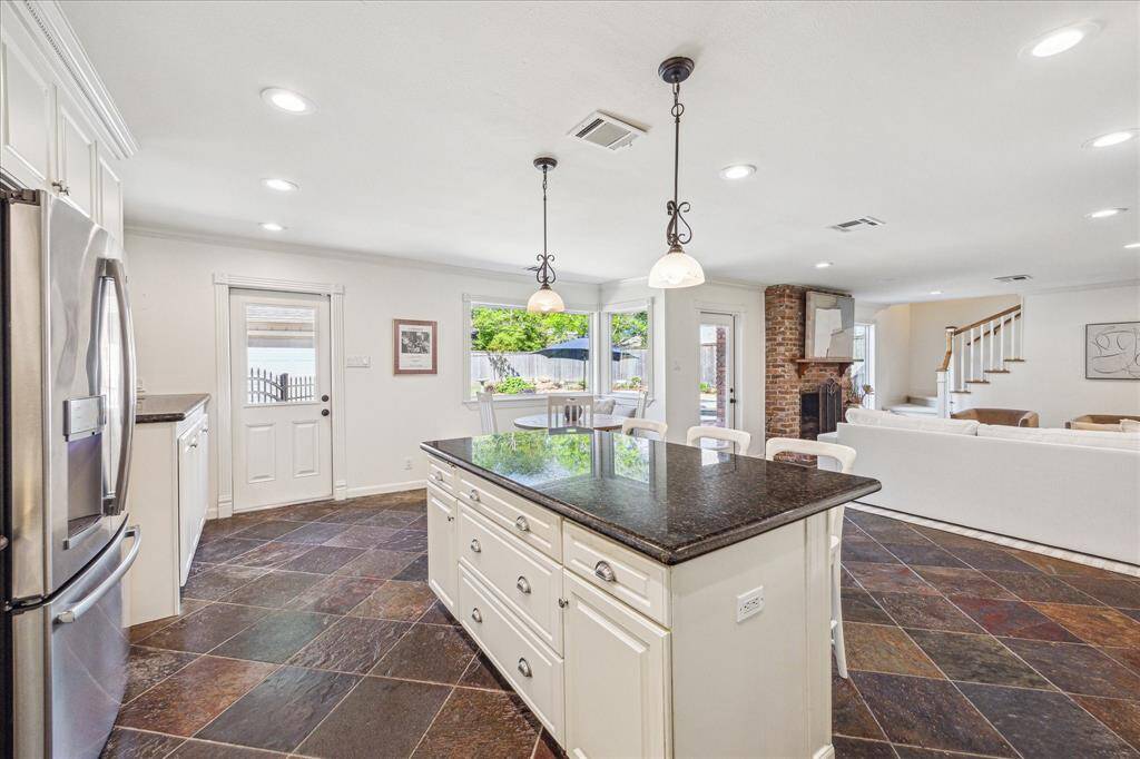 The view into the family room, breakfast nook, and outdoor space offers a compelling invitation to entertain.