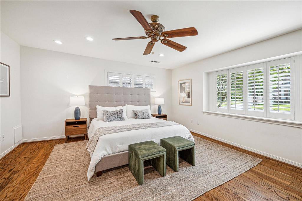 Perfectly and privately tucked away, you will find the expansive primary bedroom can be found downstairs and features beautiful hardwood floors, en suite primary bath and large walk in closet.
