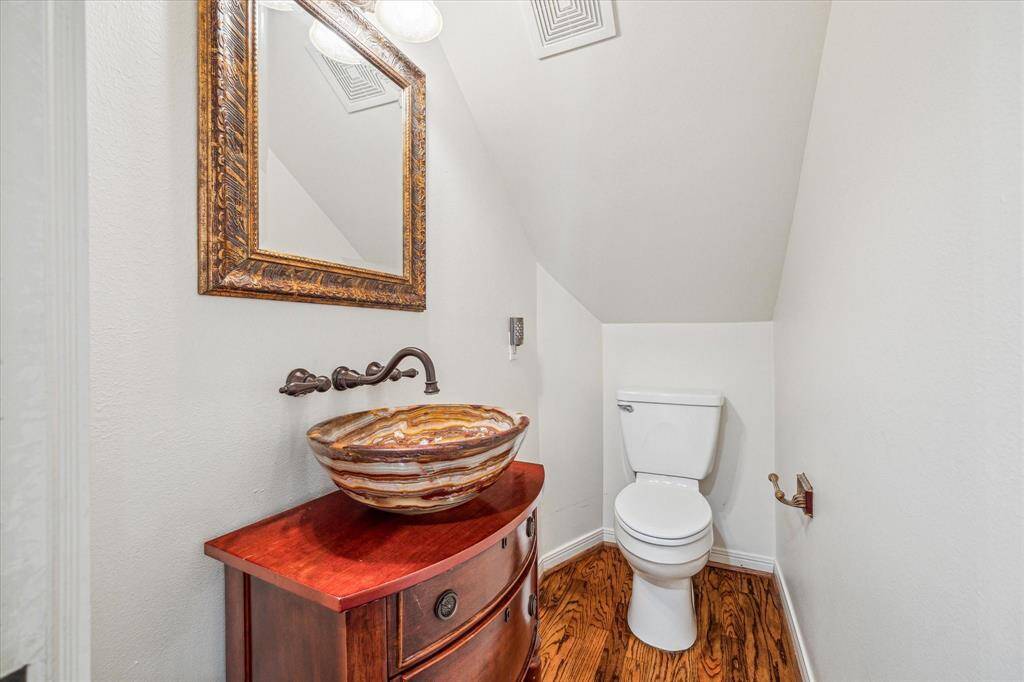 Tucked away from the family room is the half bath for guests providing privacy.