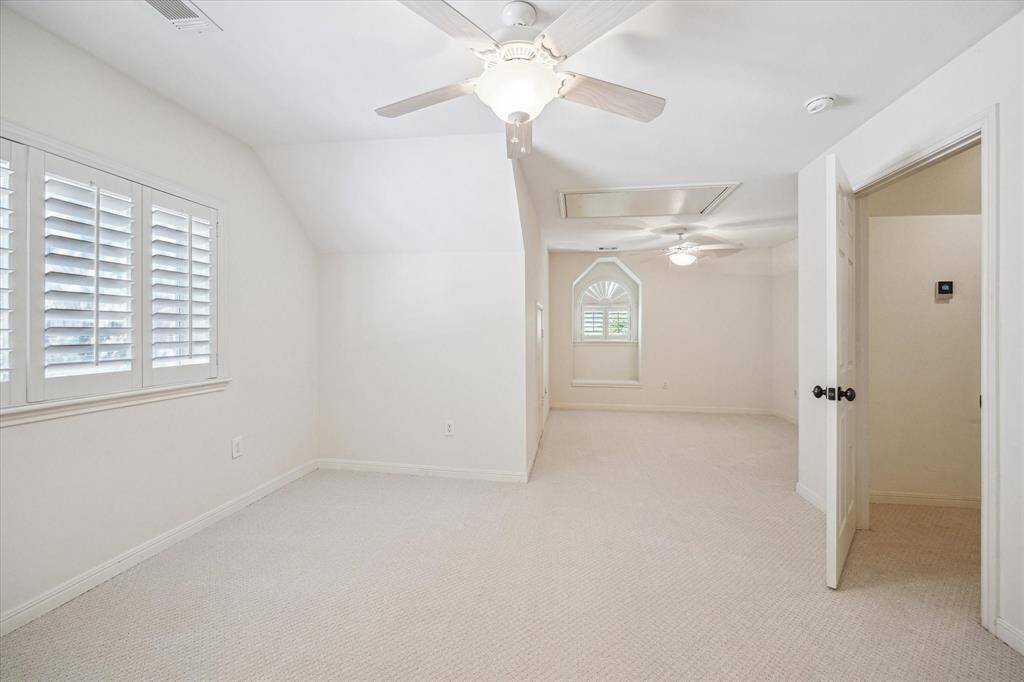 The upstairs secondary bedroom is exceptionally spacious, accommodating various bed configurations, and includes an en-suite bath, plantation shutters and new carpet.