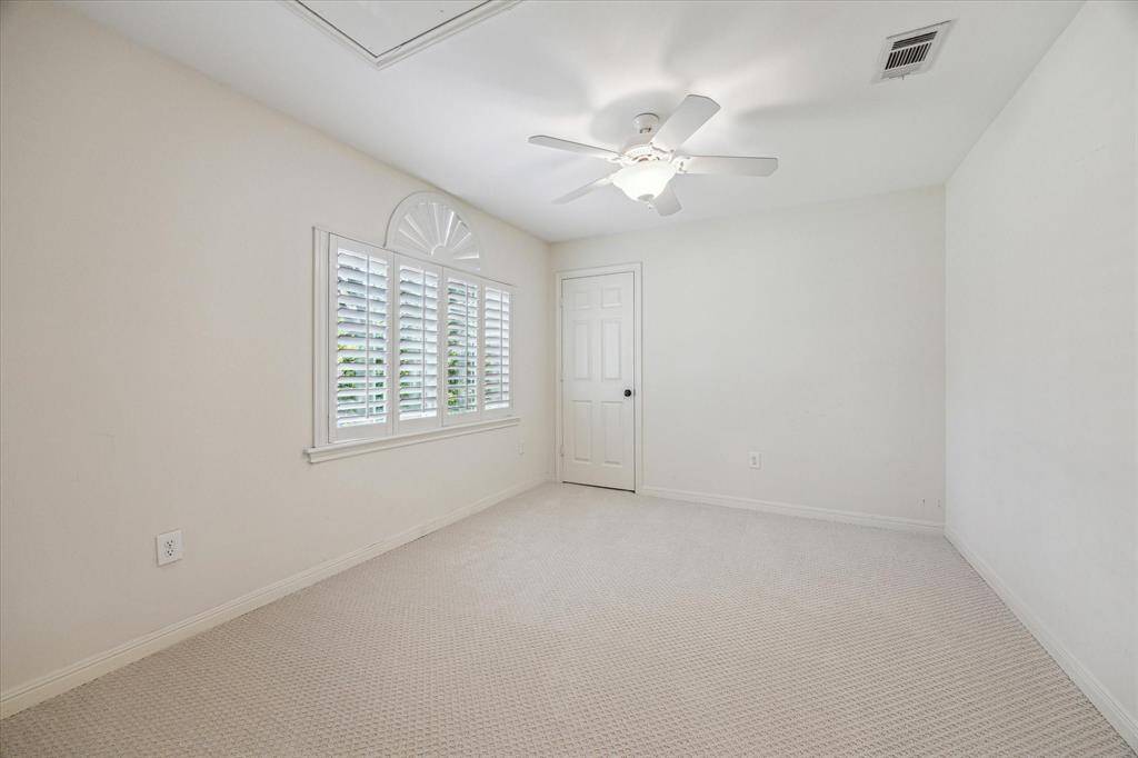 Spacious third bedroom upstairs has plantation shutters and new carpet.