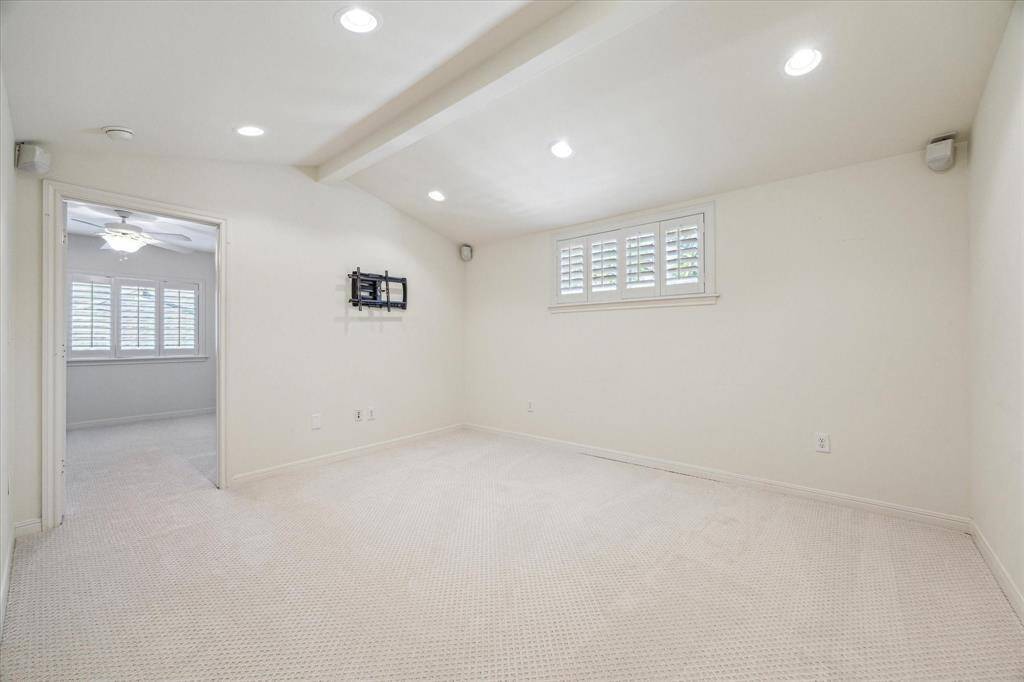 Tucked between the upstairs bedrooms is this stunning gameroom. This expansive space is perfect for a media room, filled with toys, desks, and TVs. Imagine cozy movie nights, a dedicated play area for kids, or a versatile workspace. The possibilities are endless in this inviting and multifunctional room!