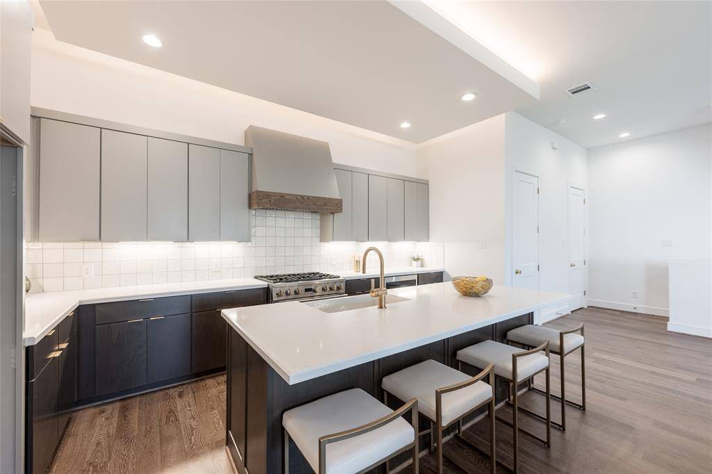 Striking dual-tone cabinetry adds contrast and sophistication to this sleek, modern kitchen.