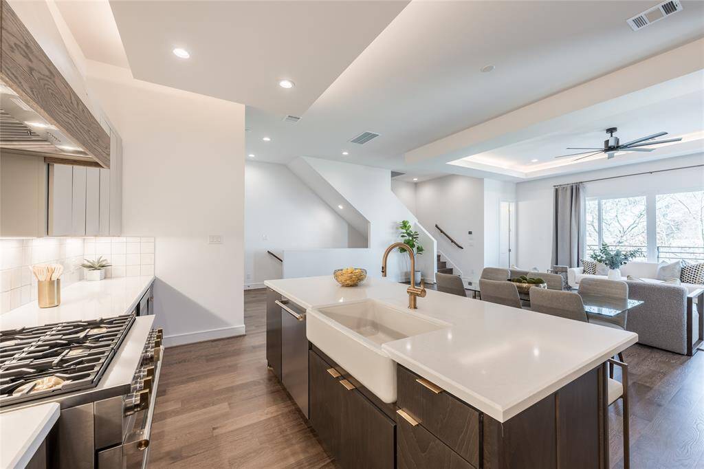 The dropdown ceiling enhances the kitchen’s architectural appeal, framing the workspace with soft lighting.