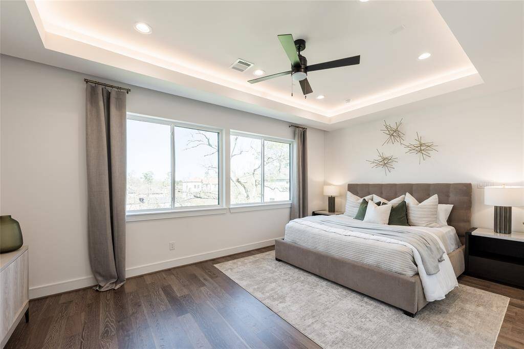 A spacious retreat featuring a recessed tray ceiling with ambient LED lighting for a soft, luxurious glow.