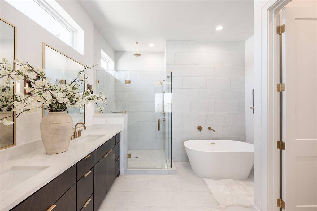 A spa-inspired primary bath featuring sleek lines, premium finishes, and a calming neutral palette.