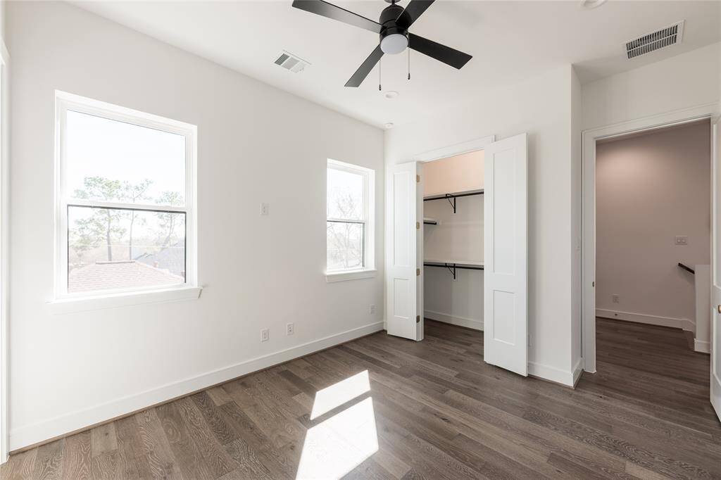 Spacious secondary bedrooms feature high ceilings and sleek architectural finishes.