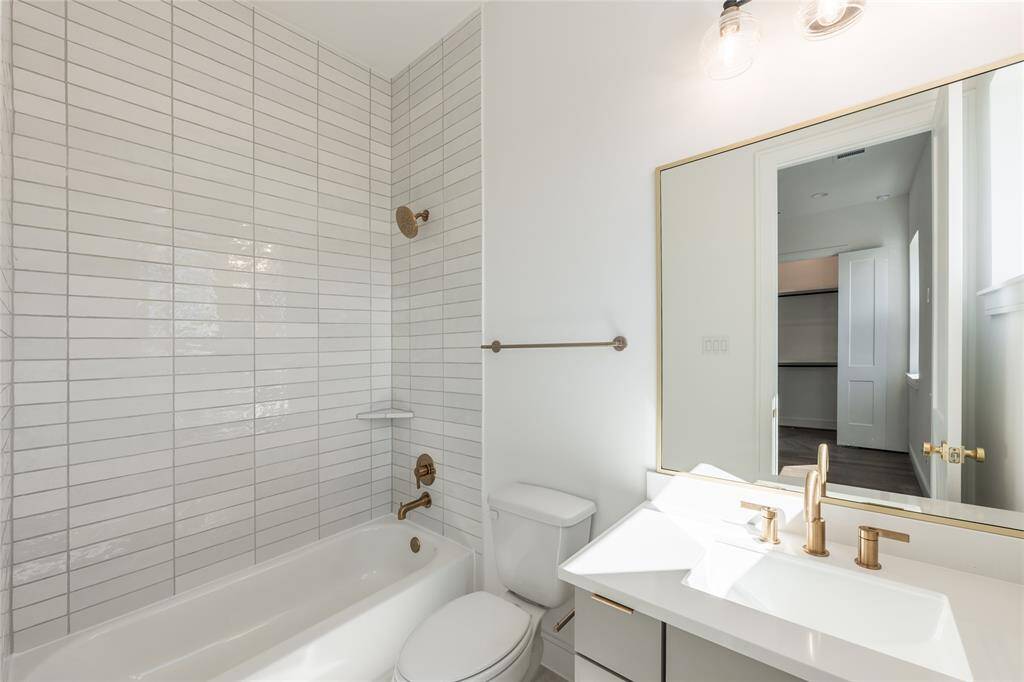 Thoughtfully appointed secondary bathrooms showcase modern fixtures and streamlined vanities.