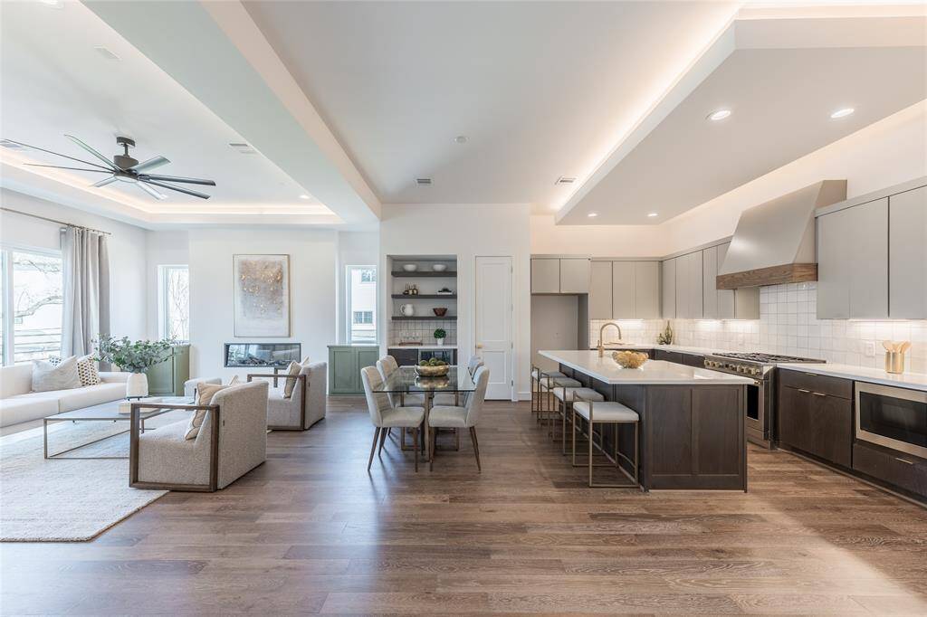 The seamless flow between kitchen, dining, and living areas is anchored by sleek architectural finishes.