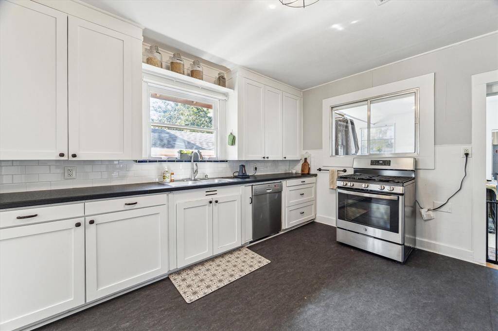 The stylish kitchen boasts stainless steel appliances and ample storage.