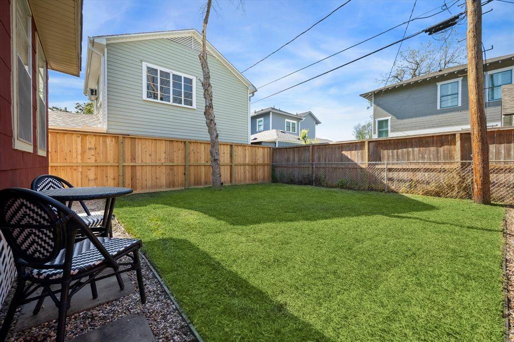 Shaded by mature trees, the backyard is a peaceful retreat, ready for gardening, entertaining, or relaxing afternoons.