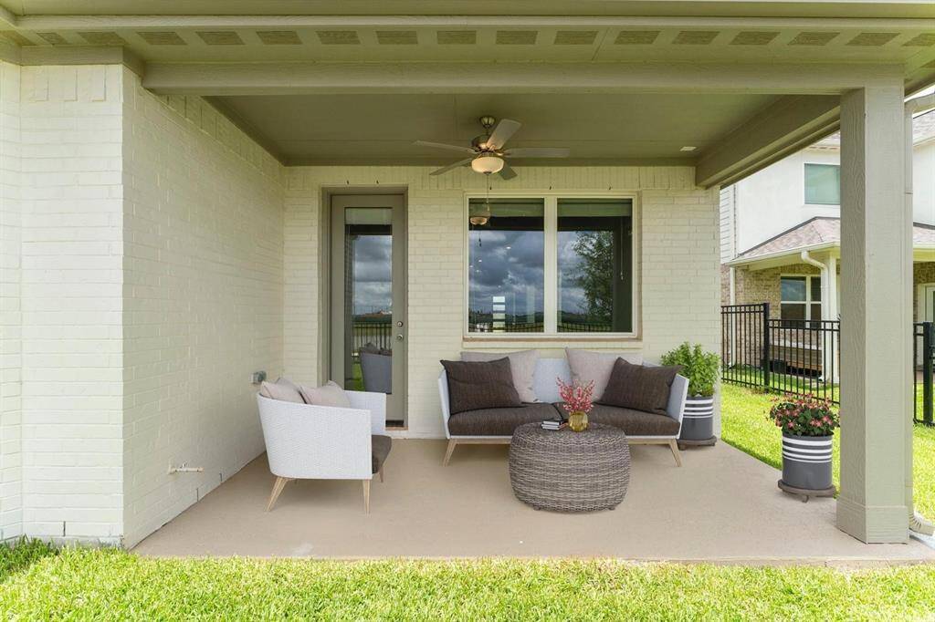 You can see the LAGOON from your backyard! Cozy covered patio features a ceiling fan for comfort, overlooking the lake and Lagoon.