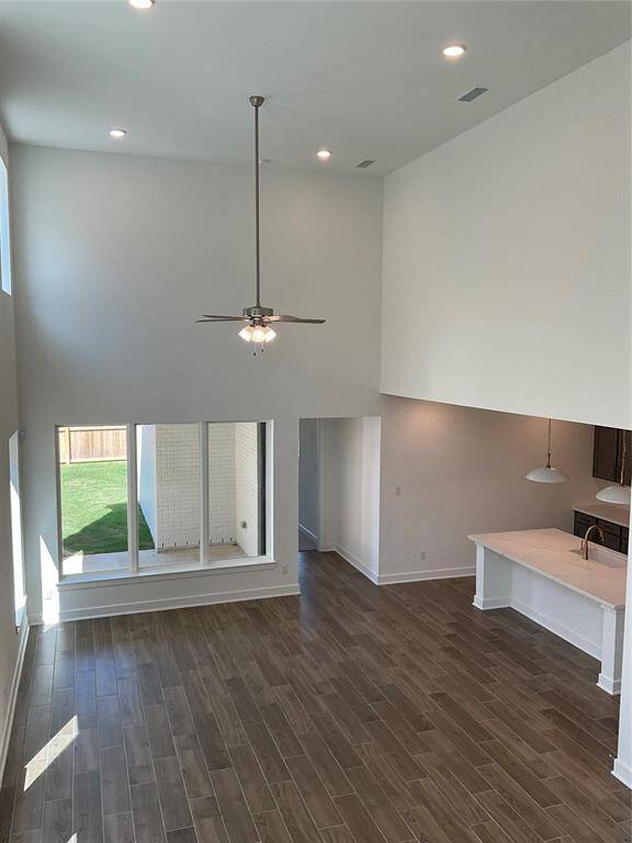 This kitchen gleams with natural light and stylish pendant fixtures, creating a warm, inviting space.