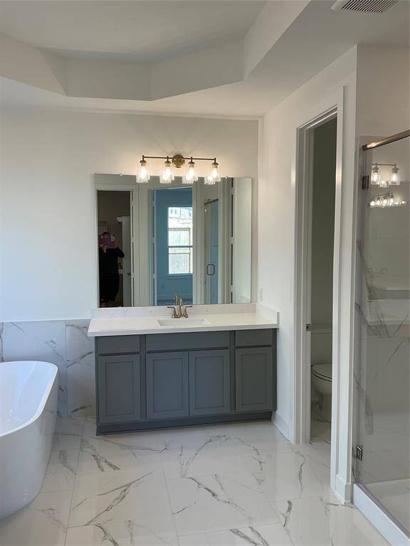 Luxurious master bath with dual sinks, a freestanding tub, and a separate shower.