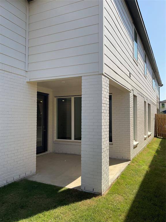 The cozy, covered patio is ideal for relaxation and enjoying the outdoors.