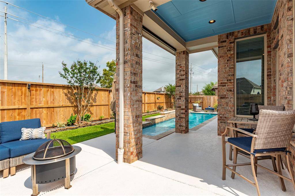 This photo showcases the full gutters which are piped directly in-ground with hard PVC drains; PVC drain grates throughout the front and back yard as well.